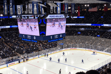 Inside Scotiabank Arena during a Toronto Maple Leafs game, showing the ice, centre scoreboard and packed stands.