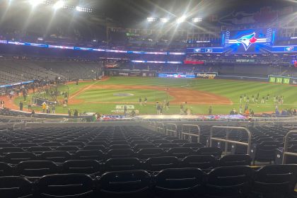 Toronto Blue Jays field at Rogers Centre before a game, with players warming up under the stadium lights.