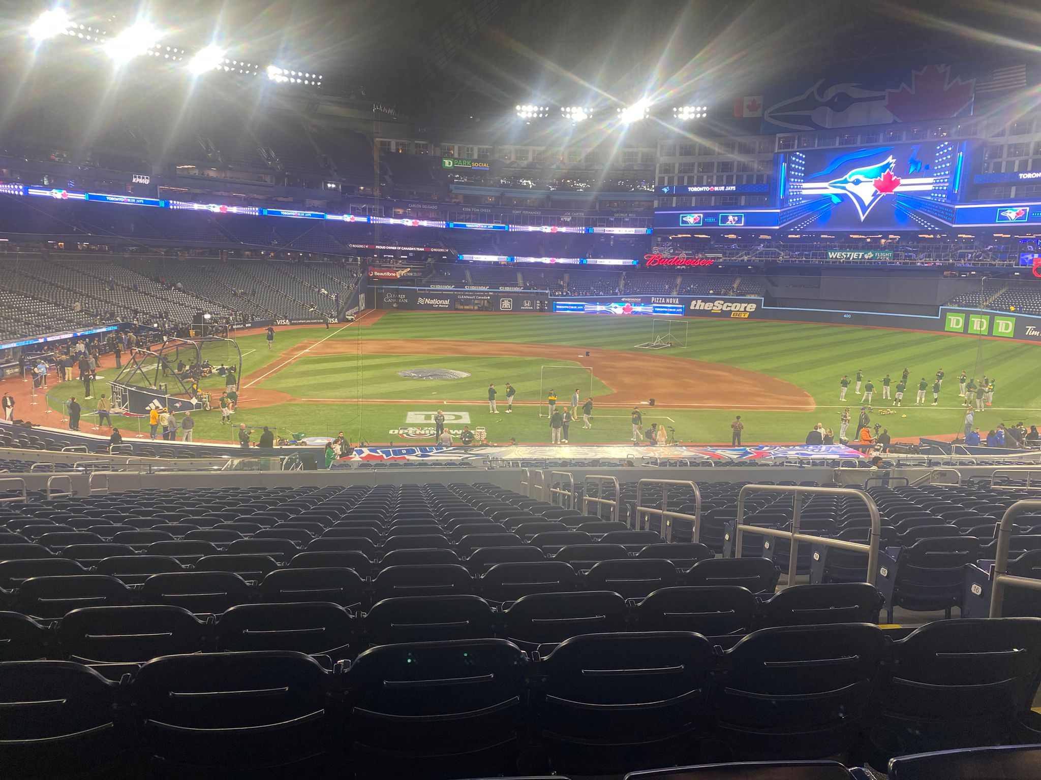 Toronto Blue Jays field at Rogers Centre before a game, with players warming up under the stadium lights.