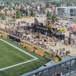 Hamilton Tiger-Cats game day at Hamilton Stadium, featuring The Hammer fan zone and fans gathering beside the field.